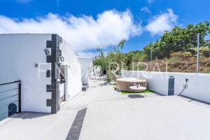 a patio with a white fence and a bench at Finca Rural Triana in Santa Cruz de Tenerife