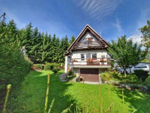 a house with a green yard with a house at Holiday Home Hůrka by Interhome in Horní Planá