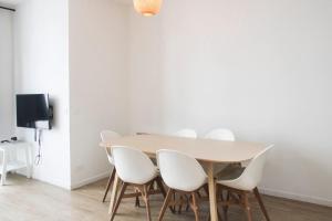 a dining room with a table and white chairs at Spacious appt close to Place Monge in Paris