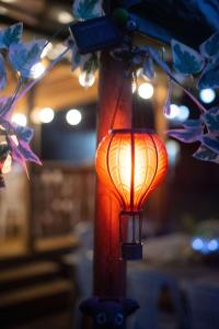 an orange lantern is hanging from a pole at Dordogne Glamping in Bouzic