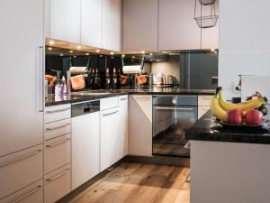 a kitchen with bananas and apples on a counter at Apartment Haus Sunneschy Whg- 202 by Interhome in Parpan