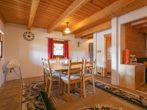 a dining room with a wooden table and chairs at Holiday Home Pod Liščím Kopcem by Interhome in Horní Branná