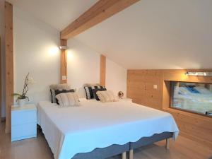 a bedroom with a large white bed in a room at Apartment L'Etoile du Matin 1er by Interhome in Champex