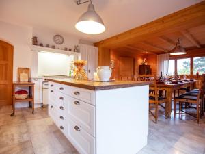 a kitchen with a counter and a dining room at Chalet Chalet Le Haut Pré by Interhome in Villars-sur-Ollon