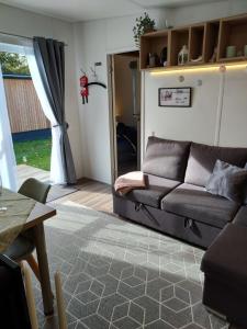 a living room with a couch and a table at Holiday Home Alex by Interhome in Wemding