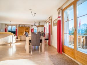 a dining room and living room with a table and chairs at Apartment Tga Stgirat Obergeschoss by Interhome in Malmigiuer