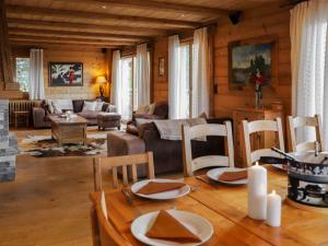 a living room with a table and chairs at Chalet Chalet Picoulet by Interhome in Villars-sur-Ollon