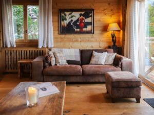 a living room with a couch and a table at Chalet Chalet Picoulet by Interhome in Villars-sur-Ollon