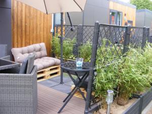 a patio with a table and an umbrella at Holiday Home Ulrike by Interhome in Wemding