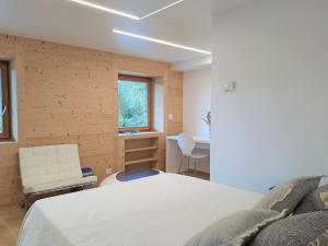 a bedroom with a bed and a table and a chair at Apartment Etoile du Matin rez by Interhome in Champex