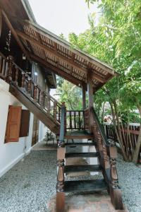 a wooden staircase leading up to a house at Maison Barn Laos in Luang Prabang