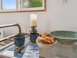 Østermarie的住宿－Holiday Home Edele - 3-8km from the sea in Bornholm by Interhome，一张桌子,上面放着蜡烛和一碗面包