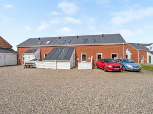 a house with two cars parked in front of it at Apartment Ilka - all inclusive - 2-3km from the sea by Interhome in Sønderby