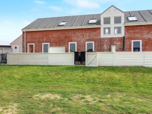 a house with a white fence in front of it at Apartment Ilka - all inclusive - 2-3km from the sea by Interhome in Sønderby