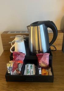 a black container with a tea kettle on a table at Crowne Plaza Plymouth, an IHG Hotel in Plymouth