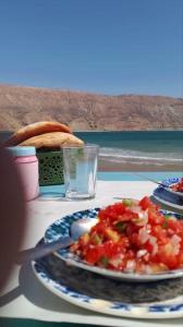 una mesa con un plato de comida y un sándwich en Tambarkiyt House Studio Appartement - Aourir Agadir en Agadir