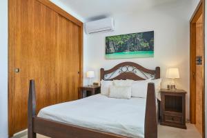 a bedroom with a bed and two tables with lamps at Finca Garrovers de Shorta in S'Horta +35 photos