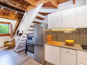 a kitchen with a stainless steel refrigerator and a staircase at Apartment Nevat by Interhome in Pla de l'Ermita