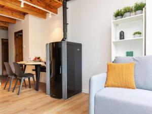 a living room with a black refrigerator next to a couch at Apartment Nevat by Interhome in Pla de l'Ermita