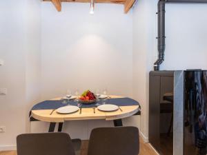 a table with wine glasses and a bowl of fruit on it at Apartment Nevat by Interhome in Pla de l'Ermita +16 photos