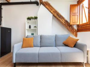 a blue couch with orange pillows in a living room at Apartment Nevat by Interhome in Pla de l'Ermita