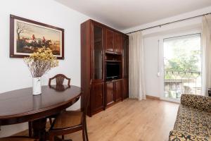 a living room with a dining room table and a window at Olivais Vintage by Homing in Lisbon