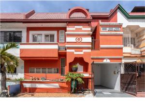una casa naranja y blanca con una puerta en Home Near Airport & MOA for Big Family Groups, en Manila