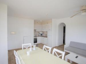 a kitchen and dining room with a table and chairs at Apartment Son Bou Gardens Apt 3 dorm by Interhome in Son Bou