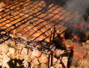 a bunch of ribs and meat on a grill at Casa rural El Salero Piscina campo de fútbol y voley chimenea barbacoa in Moratalla