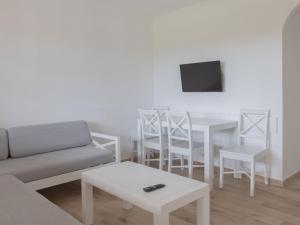 a living room with a couch and a table at Apartment Son Bou Gardens PLUS by Interhome in Son Bou
