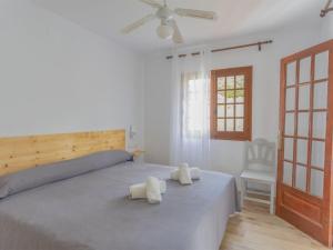 a bedroom with a bed with two towels on it at Apartment Son Bou Gardens PLUS by Interhome in Son Bou