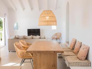 a living room with a table and a couch at Holiday Home Son Bou Sunset 49 by Interhome in Alaior