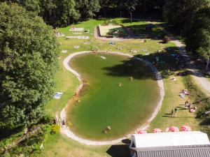 an aerial view of a park with people in the water at Apartment Les Hameaux de la Perrière-1 by Interhome in Saint-Colomban-des-Villards