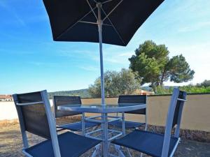 a blue table and chairs under an umbrella at Villa Benestar by Interhome in El Toro