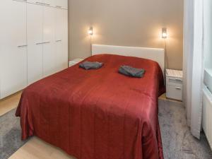 a bedroom with a red bed with two pillows on it at Holiday Home Kelotähti a 37 by Interhome in Saariselka