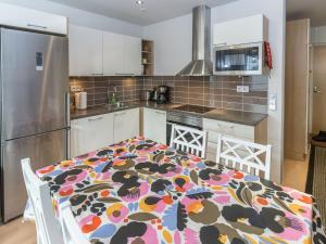 a kitchen with a table with a flowered table cloth at Holiday Home Kelotähti a 37 by Interhome in Saariselka