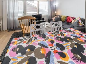 a living room with a bed with a colorful blanket at Holiday Home Kelotähti a 37 by Interhome in Saariselka