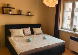 a bedroom with a bed with two candles on it at Prague 7days Apartments - FREE PARKING in Prague