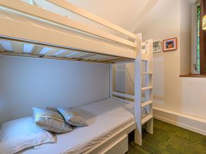 a bunk bed with two pillows on it in a room at Villa Le Château de Kergonano-4 by Interhome in Baden