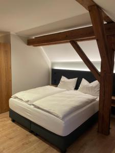 uma cama num quarto com uma cama alta em Hotel Gasthof Stieglers 