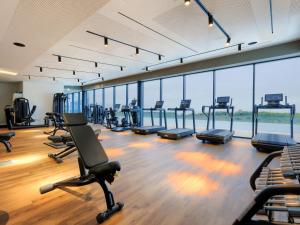 a gym with a lot of exercise equipment and windows at Holiday Home Semi-detached Villa Crveni vrh 1-2-3- by Interhome in Savudrija