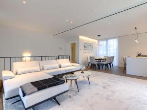 a living room with a white couch and a table at Holiday Home Semi-detached Villa Crveni vrh 1-2-3- by Interhome in Savudrija