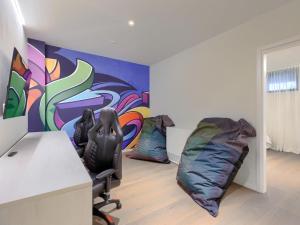 a room with a desk and chairs and a painting at Holiday Home Semi-detached Villa Crveni vrh 1-2-3- by Interhome in Savudrija +39 photos