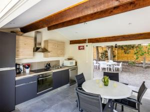 a kitchen and dining room with a table and chairs at Holiday Home Le Clos Saint Emilie - Tennis & piscine by Interhome in Béziers
