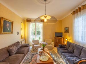 a living room with a couch and a table at Holiday Home Le Clos Saint Emilie - Tennis & piscine by Interhome in Béziers