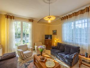 a living room with a couch and a table at Holiday Home Le Clos Saint Emilie - Tennis & piscine by Interhome in Béziers