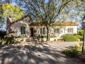 a stone house with a tree in front of it at Holiday Home Le Clos Saint Emilie - Tennis & piscine by Interhome in Béziers