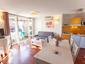 a kitchen and living room with a table and a couch at Apartment Les Hameaux de La Chalosse-3 by Interhome in Cassen +25 photos