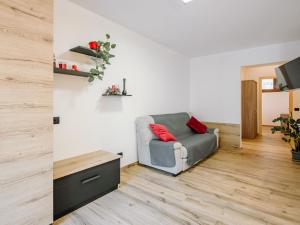 a living room with a chair and a table at Apartment Enrosadira-9 by Interhome in Alba di Canazei +42 photos