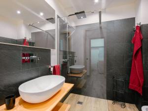 a bathroom with a large white tub and a sink at Apartment Enrosadira-9 by Interhome in Alba di Canazei